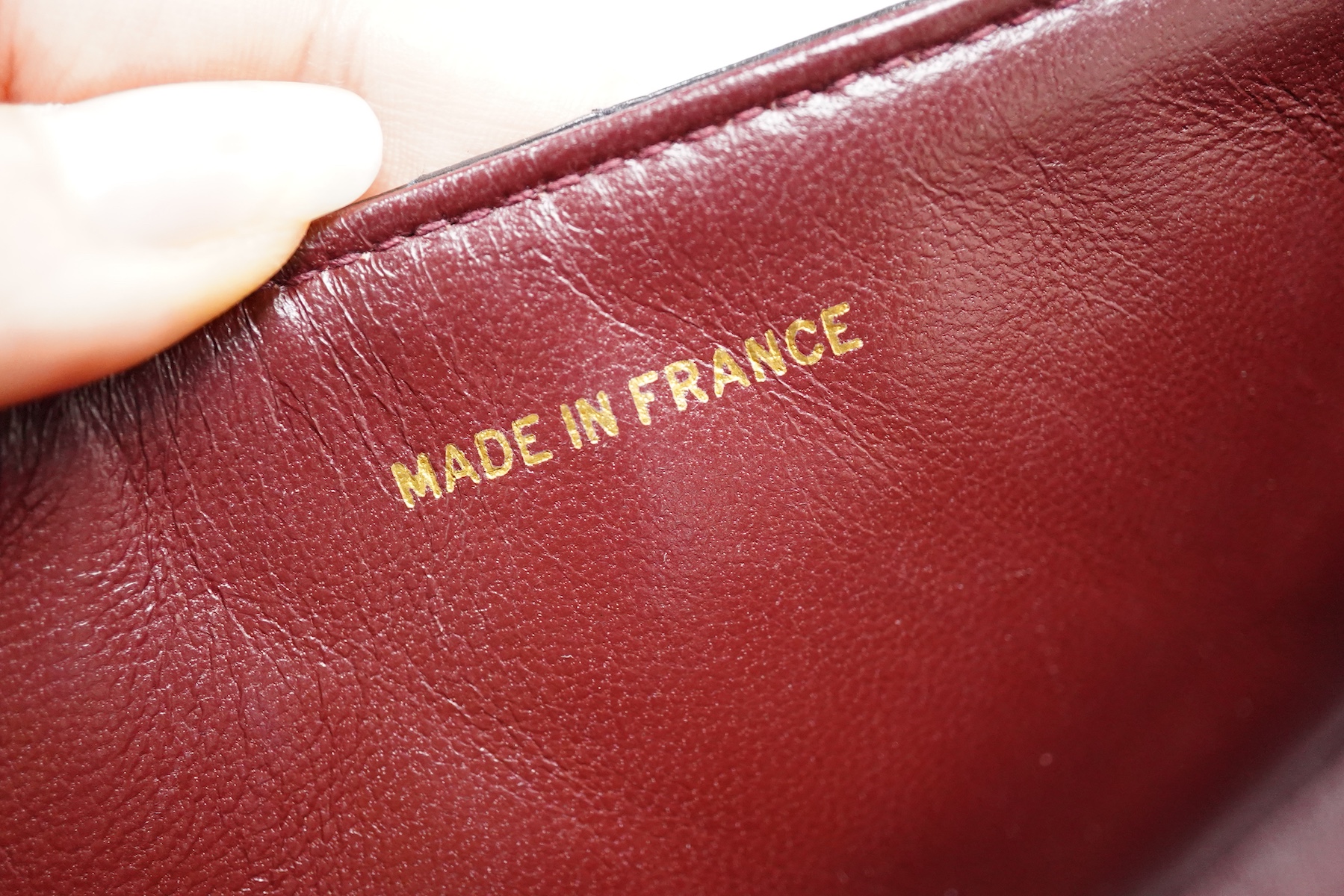 A late 1980’s Chanel black leather Diana shoulder bag with original dust cover and bag, Chanel authenticity card numbered 1944645, interior date code rubbed, 23cm wide, Provenance: Purchased by the vendor, 26 Old Bond St